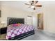 King-size bed in a main bedroom with a ceiling fan and en-suite bathroom access at 13165 W Ventura St, Surprise, AZ 85379