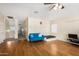Versatile bonus room with hardwood floors and blue couch at 13165 W Ventura St, Surprise, AZ 85379