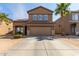 Two-story home with a two-car garage and desert landscaping at 13165 W Ventura St, Surprise, AZ 85379