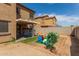 Grass backyard with playground equipment and covered patio at 13165 W Ventura St, Surprise, AZ 85379