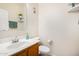 Simple bathroom with toilet, sink, and floating shelves at 13165 W Ventura St, Surprise, AZ 85379