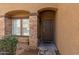 Inviting entryway with stone accents and a dark brown door at 13165 W Ventura St, Surprise, AZ 85379