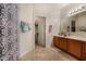 Clean bathroom with double vanity, shower, and linen closet at 13165 W Ventura St, Surprise, AZ 85379
