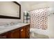 Clean bathroom with a shower/tub combo and wood vanity at 13165 W Ventura St, Surprise, AZ 85379