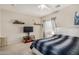 Comfortable bedroom with a large bed, TV stand, and decorative shelves at 13165 W Ventura St, Surprise, AZ 85379
