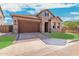 Single story home with stone and stucco exterior, and a brown garage door at 5719 E Sayan St, Mesa, AZ 85215