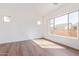 Light and airy bedroom with large windows and wood-look floors at 5719 E Sayan St, Mesa, AZ 85215