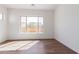 Spacious bedroom with large window and wood-like flooring at 5719 E Sayan St, Mesa, AZ 85215