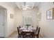 Bright dining room with wood table and chairs, white shutters and ceiling fan at 16015 E El Lago Blvd # 102B, Fountain Hills, AZ 85268