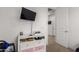 Bedroom with TV, dresser, and access to hallway at 18767 W Canterbury Dr, Surprise, AZ 85388