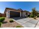 House exterior with brown garage door and driveway at 18767 W Canterbury Dr, Surprise, AZ 85388