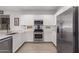 Modern kitchen with stainless steel appliances and white cabinets at 18767 W Canterbury Dr, Surprise, AZ 85388
