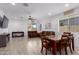 Bright living room with tile floors, dining area, and sliding glass door to backyard at 18767 W Canterbury Dr, Surprise, AZ 85388