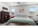 Bedroom with queen bed, dresser, and large window at 18767 W Canterbury Dr, Surprise, AZ 85388