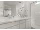 Bathroom with double vanity, large mirror, and a walk-in shower at 18767 W Canterbury Dr, Surprise, AZ 85388