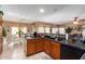 View of kitchen with breakfast nook, dark countertops, and wooden cabinets at 15831 W Marconi Ave, Surprise, AZ 85374