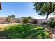 Landscaped backyard with grassy area and storage shed at 15831 W Marconi Ave, Surprise, AZ 85374