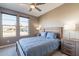 Bright bedroom with double windows, wooden bed frame, and neutral tones at 247 E Las Puertas Ln, San Tan Valley, AZ 85140