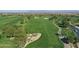 Aerial view of a golf course community with houses and mountain views at 247 E Las Puertas Ln, San Tan Valley, AZ 85140