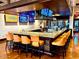 L-shaped bar with granite top and orange stools at 247 E Las Puertas Ln, San Tan Valley, AZ 85140