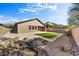 Landscaped backyard with artificial turf and rock features at 13789 E Geronimo Rd, Scottsdale, AZ 85259