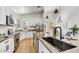 Bright kitchen featuring white cabinets, quartz countertops, and a large island at 13789 E Geronimo Rd, Scottsdale, AZ 85259