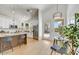 Open concept kitchen with white cabinets, island seating, and access to backyard at 13789 E Geronimo Rd, Scottsdale, AZ 85259
