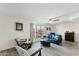 Living room with teal sofa and wood-look floors at 5136 N 31St Pl # 648, Phoenix, AZ 85016