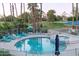 Community pool with patio furniture and umbrellas at 5136 N 31St Pl # 648, Phoenix, AZ 85016
