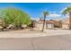 Tan house with solar panels, two-car garage, and desert landscaping at 8737 W Kimberly Way, Peoria, AZ 85382