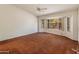 Bright living room featuring a large window and brown carpet at 8737 W Kimberly Way, Peoria, AZ 85382