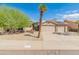 Tan house with solar panels, two-car garage, and desert landscaping at 8737 W Kimberly Way, Peoria, AZ 85382
