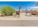Tan house with solar panels, two-car garage, and desert landscaping at 8737 W Kimberly Way, Peoria, AZ 85382