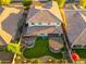 Aerial view of house with backyard oasis, including a pergola and fire pit at 14674 W Pasadena Ave, Litchfield Park, AZ 85340