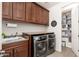 Laundry room with washer, dryer, and ample cabinet storage at 14674 W Pasadena Ave, Litchfield Park, AZ 85340