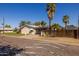 House exterior with a wooden fence and palm trees at 801 E Echo Ln, Phoenix, AZ 85020