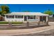 Newly remodeled mid-century modern home with a gray fence and landscaping at 7508 E Beatrice St, Scottsdale, AZ 85257