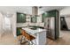 Modern kitchen with a large island, stainless steel appliances and green cabinets at 7508 E Beatrice St, Scottsdale, AZ 85257