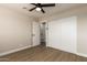 Bright bedroom with ceiling fan, new flooring, and spacious closet at 7508 E Beatrice St, Scottsdale, AZ 85257