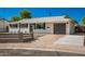 Newly remodeled mid-century modern home with a gray fence and landscaping at 7508 E Beatrice St, Scottsdale, AZ 85257