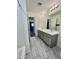 Double vanity bathroom with gray cabinets and tile floor at 10816 W Melvin St, Avondale, AZ 85323