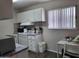 Small kitchen with white cabinets, patterned backsplash, and appliances at 825 N Hayden Rd # C207, Scottsdale, AZ 85257