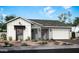 Modern farmhouse exterior with stone and white siding at 4780 W Flat Iron Ct, Queen Creek, AZ 85144