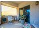 Relaxing patio with seating area, potted plants, and sliding glass door at 846 N Pueblo Dr # 110, Casa Grande, AZ 85122