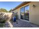 Private backyard with a water feature and sliding glass door access at 36194 N Copper Hollow Way, Queen Creek, AZ 85140