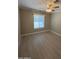 Spacious bedroom with large window and light wood-look flooring at 1922 E Yale St, Phoenix, AZ 85006