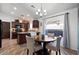 Kitchen boasts dark wood cabinets, an island, and an adjacent dining area at 38169 N Rusty Ln, San Tan Valley, AZ 85140