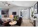 Spacious living room with leather furniture and sliding glass doors leading to the backyard at 38169 N Rusty Ln, San Tan Valley, AZ 85140