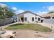 Landscaped backyard featuring a grassy lawn and gravel areas at 38169 N Rusty Ln, San Tan Valley, AZ 85140