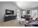 Living room featuring a large TV, comfy sofas, and access to a patio at 38169 N Rusty Ln, San Tan Valley, AZ 85140